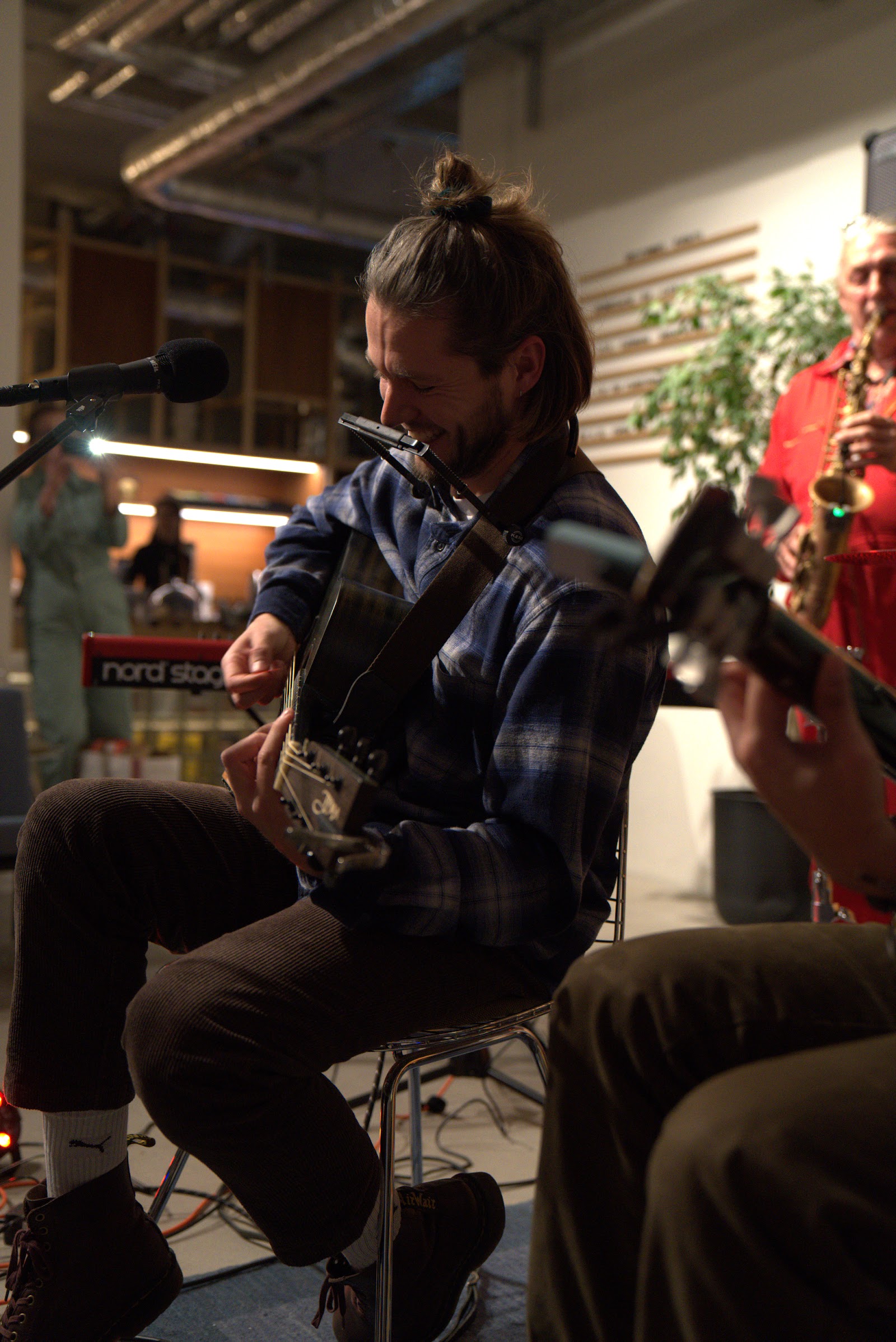 Musician playing guitar and harmonica